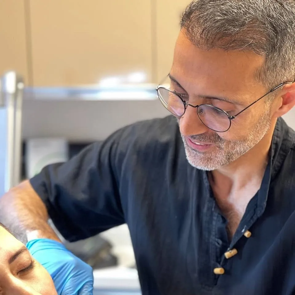 Dr. Şehriyar Nazari assessing a person at the clinic