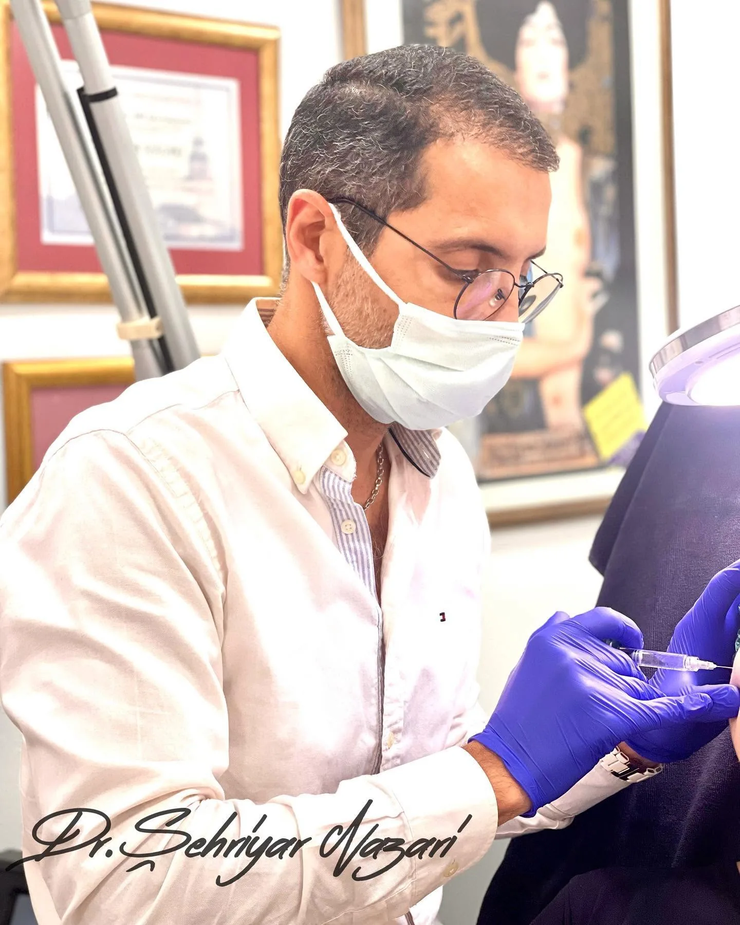 Dr. Şehriyar Nazari working with a person at the clinic